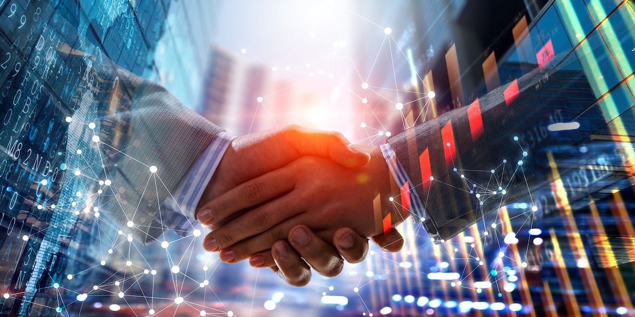 Business handshake by a man and a woman. Mixed media