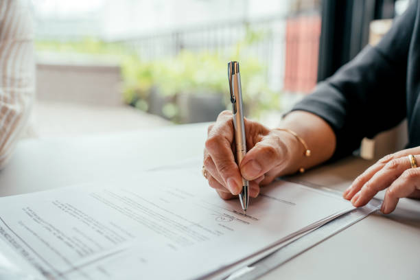 Couple closing real estate contract with real estate agent
